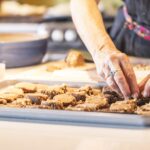 Chef Odessa Piper making hazelnut cookies in a cookie sheet